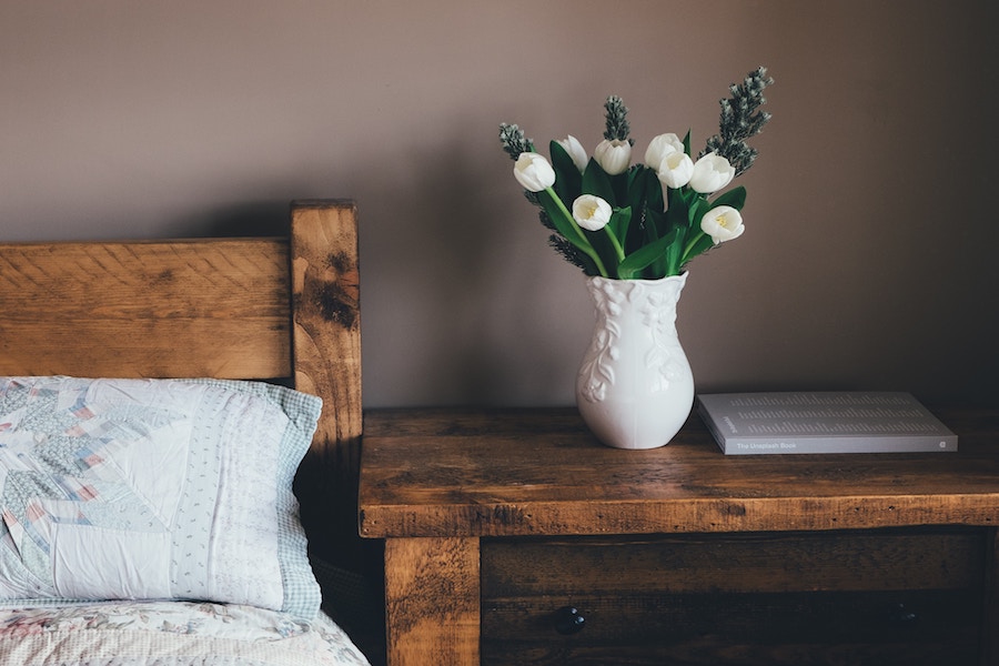 Accent furnishings including a styled side table and drawer chest